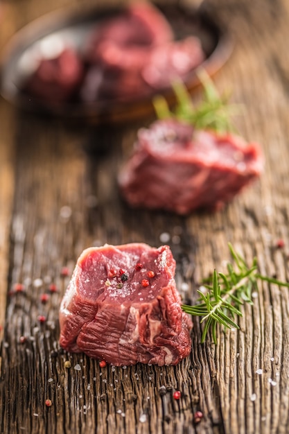 Close-up slices of beef tenterloin steak salt pepper and rosemary.