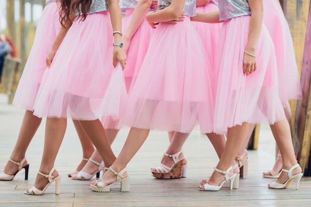 Close up of slim legs of woman wearing high heel shoes.