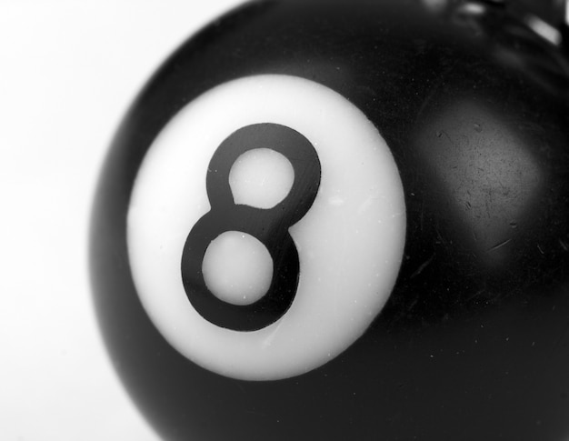 Photo close-up of a small 8-ball. in b/w