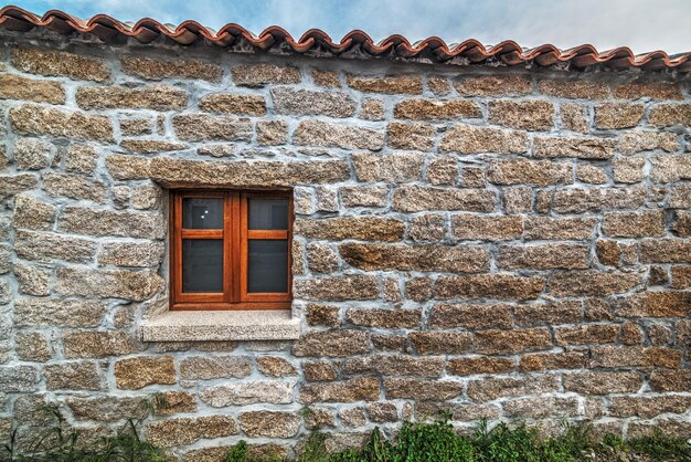 Close up of a small window in a rustic wall