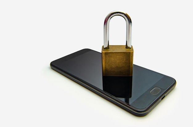 Photo close-up of smart phone and lock against white background