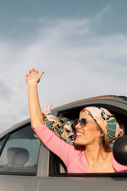 Close up smiley woman traveling by car