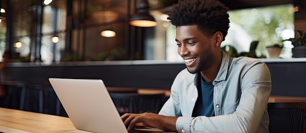 Close up of smiling African American freelancer typing on laptop enjoying remote job