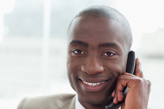 Close up of a smiling businessman on the phone