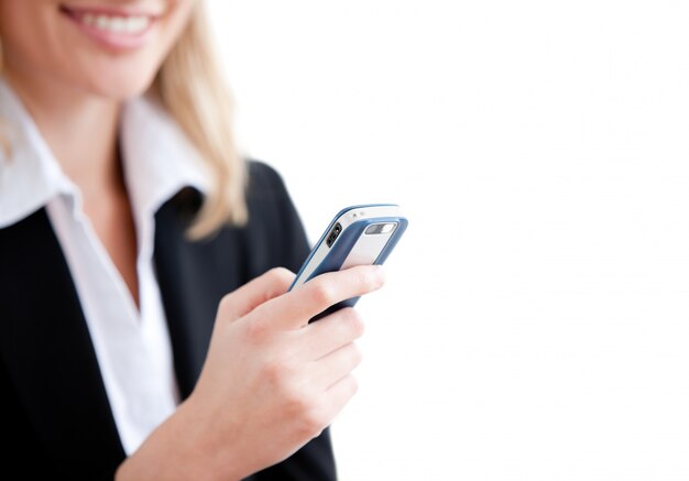 Close-up of a smiling businesswoman sending a text