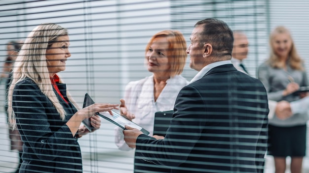 Close up  smiling employees discussing financial performance