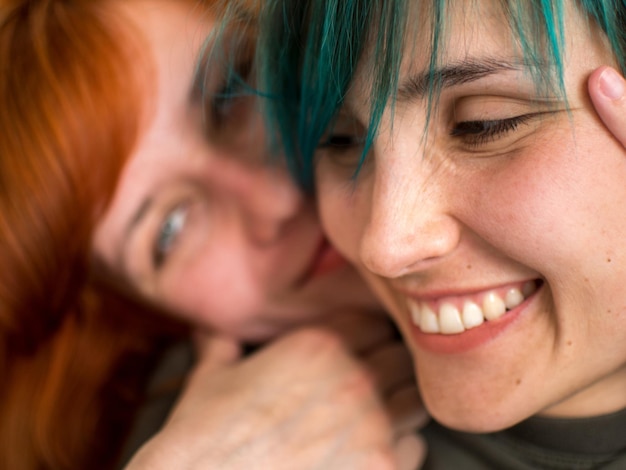 Close-up of smiling lesbian couple romancing at home
