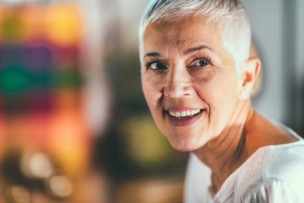 Close-up of smiling mature woman looking away