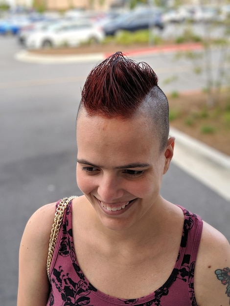 Foto close-up di una giovane donna sorridente che guarda da un'altra parte