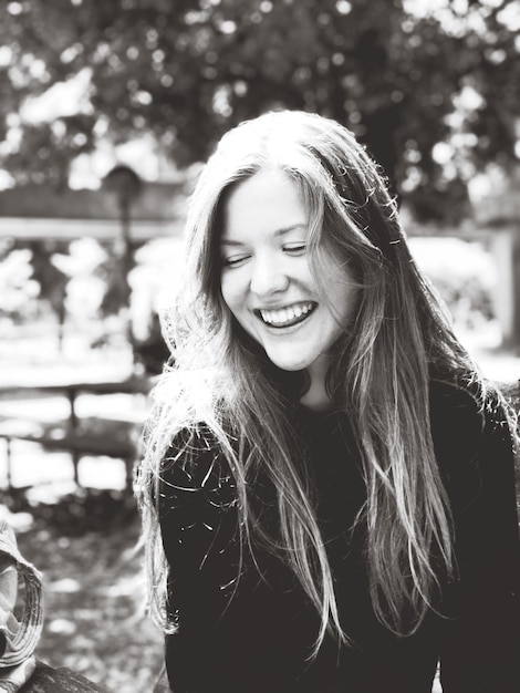 close-up of smiling young woman outdoors