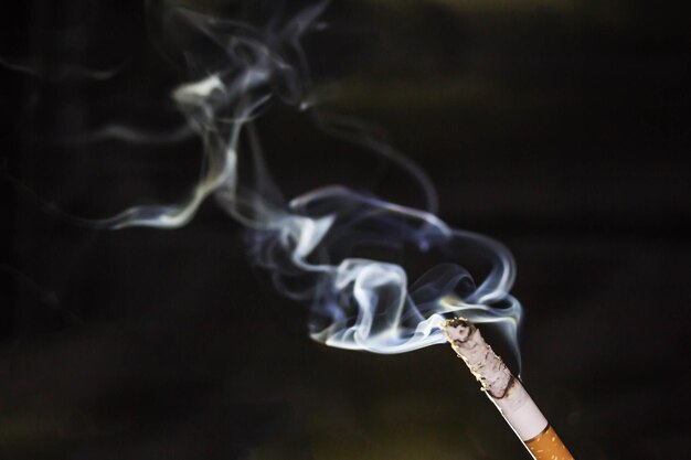 Close-up of smoke emitting from cigarette