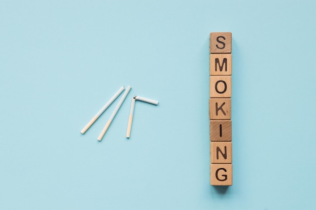 Close up of a smoking cigarettes and word no smoking on color background No smoking concept