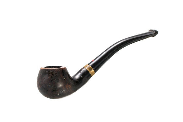 Photo close-up of smoking pipe over white background