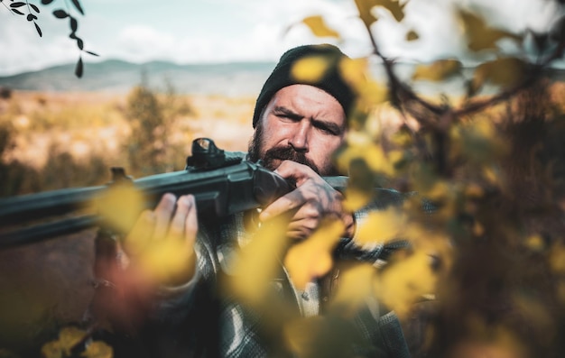 Close up snipers carbine at the outdoor hunting man holding\
shotgun hunter with shotgun gun on hunt deer hunt