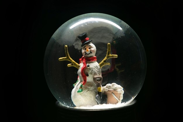 Photo close-up of snow globe against black background