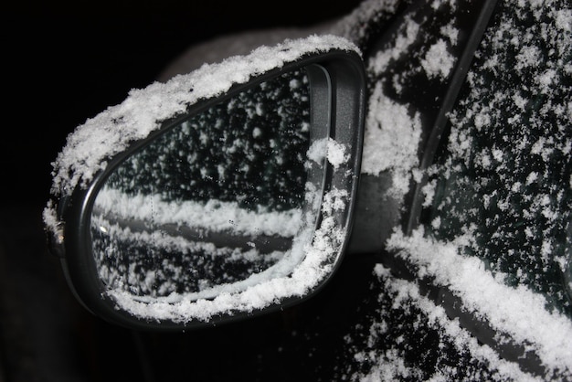 Close-up of snow on side-view mirror