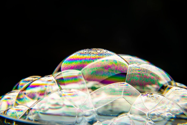 A close up of soap bubbles on a black background