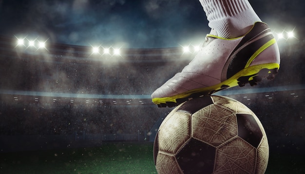 Close up of a soccer striker ready to kicks the ball at the stadium