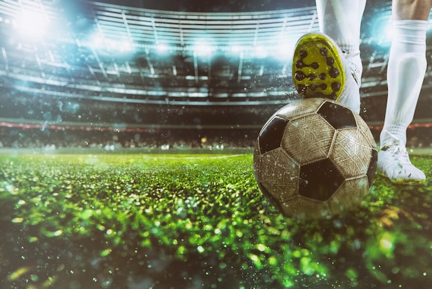 Close up of a soccer striker ready to kicks the ball at the stadium