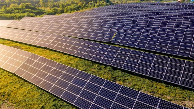 Close up solar power station panels in a row in the fields green energy