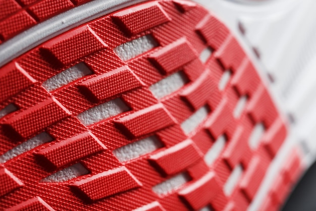 Close-up of the sole of a sport running shoe for running in red\
sports technology