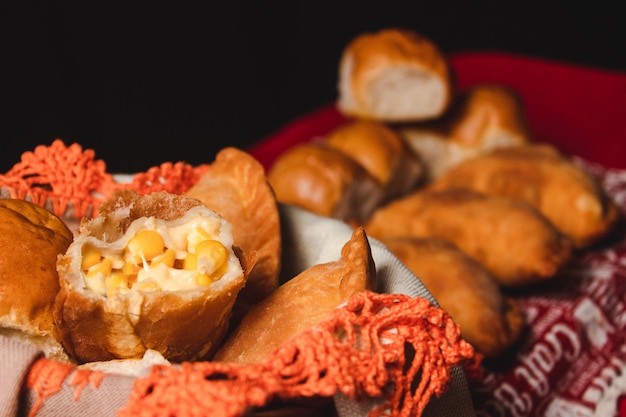 Close-up of some halved corn empanadas.