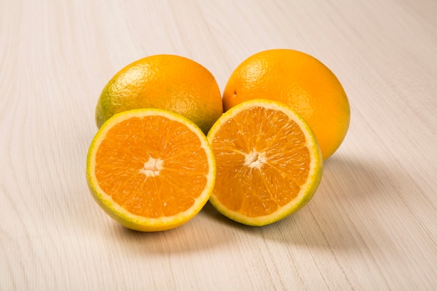 Close up of some oranges over a wooden surface. Fresh fruit.