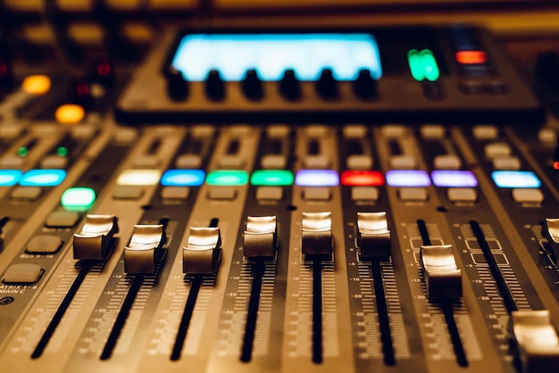 A close up of a sound mixing console