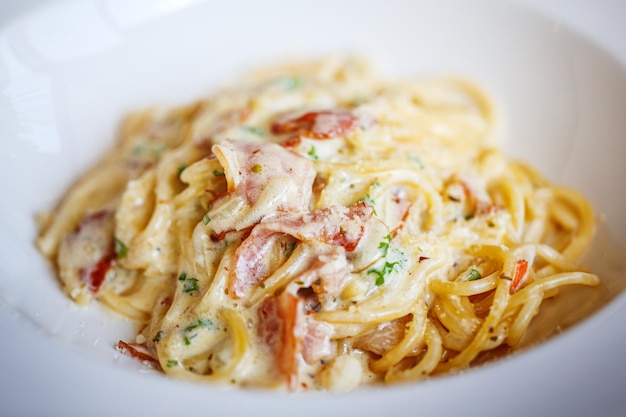 Close up Spaghetti Carbonara with bacon on white plate