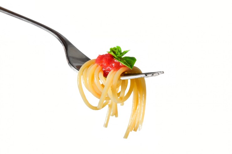 Close up of spaghetti on fork isolated on white background