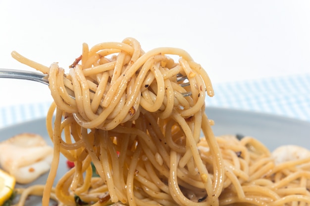 close up of spaghetti seafood with fork