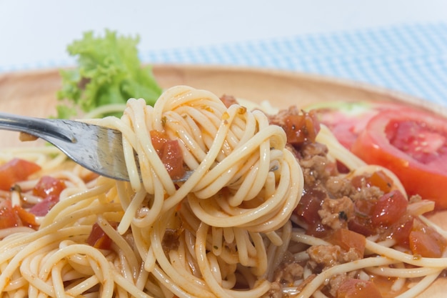 close up of spaghetti with sauce and fork