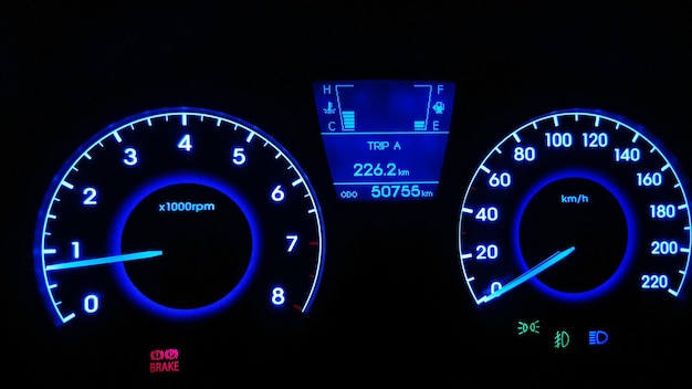 Close-up of speedometer in car at night