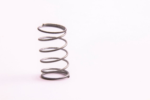 Photo close-up of spiral metal over white background