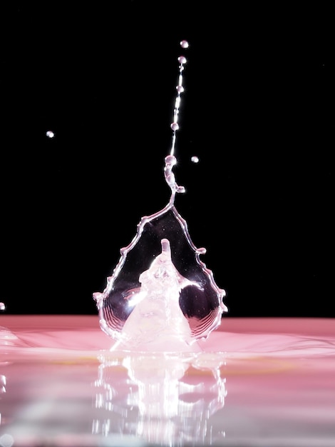 Photo close-up of splashing water over black background