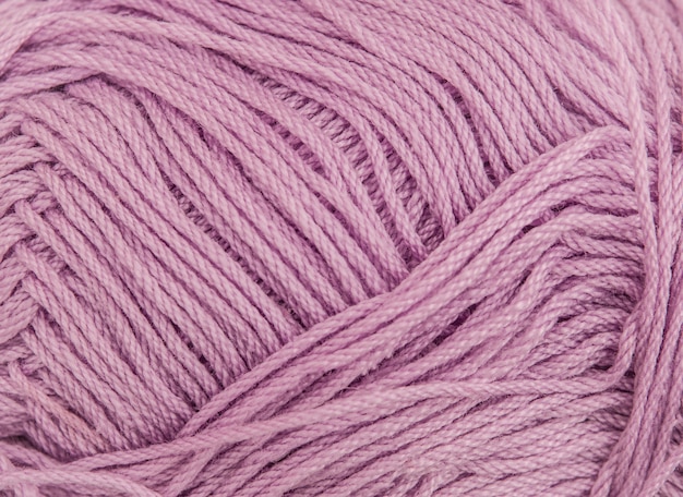 Close up of a spool of cotton pink thread