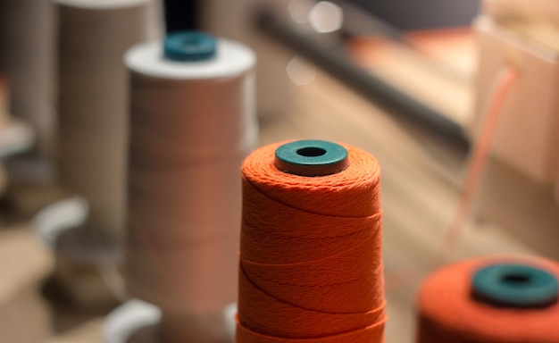 Close up spool of thread on the sewing equipment