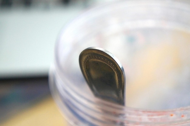 Close-up of spoon in mason jar