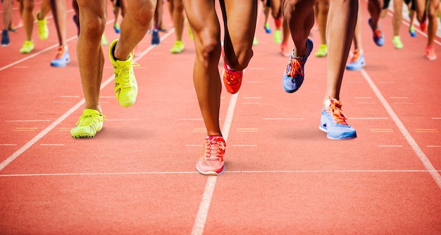 Close up of sportsman legs running  against focus of athletics track