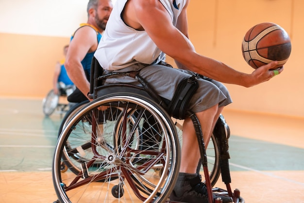 Close-up of sportsman with disability sitting in wheelchair playing basketball. High quality photo