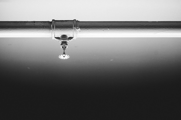 Close-up of sprinkler against wall