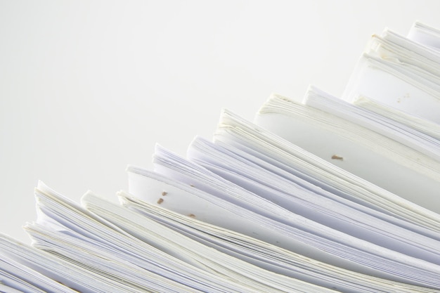 Photo close-up of stack of books against white background