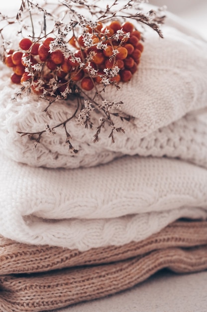 Close up stack of cozy knitted sweaters