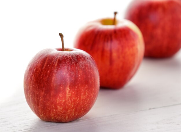 Close up stack of fresh red apple isolated on white