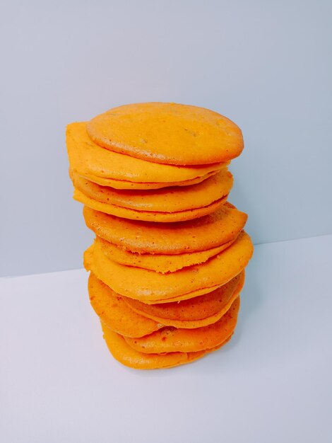 Close-up of stack on table against white background