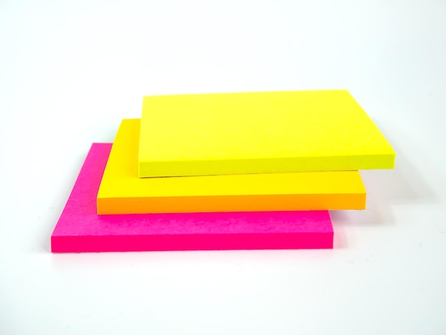 Photo close-up of stacked adhesive notes over white background