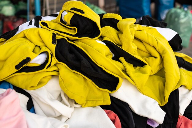 Close-up of stacked clothes for sale