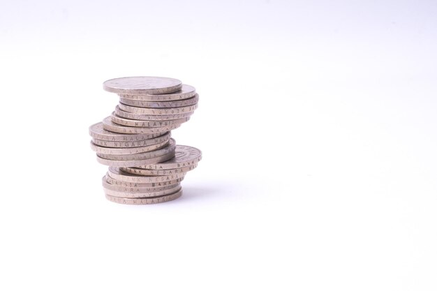 Close-up of stacked coins against white background