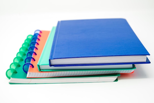 Photo close-up of stacked colorful books over white background