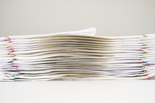 close-up of stacked files on desk against gray background